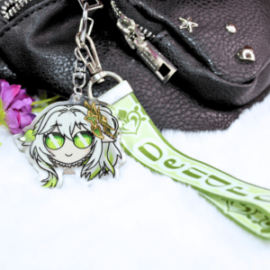 Llavero acrílico con la cara de Nahida y lanyard de tela de color verde con el símbolo de dendro y la palabra "dendro".