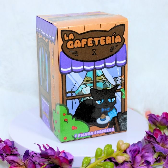Caja sorpresa de nuestra colección original La Gafetería; incluye una figura sorpresa impresa en 3D, diseñada por nosotros y pintada a mano.
